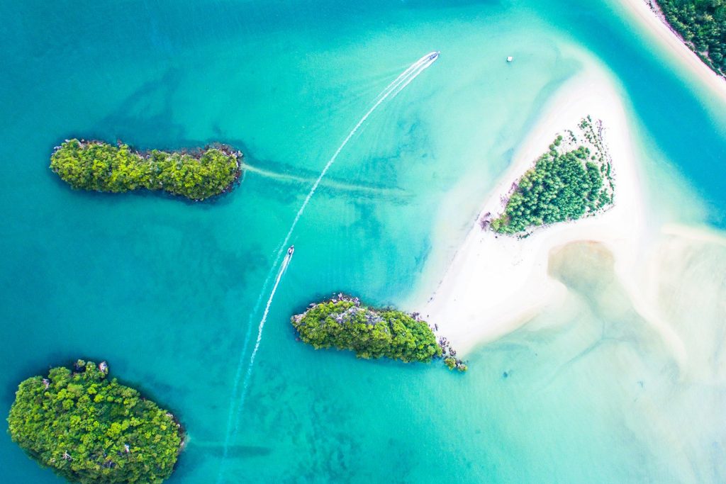 An aerial view of small islands in turquoise water