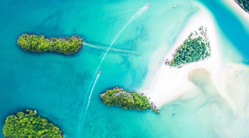 An aerial view of small islands in turquoise water