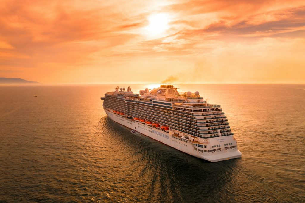 A cruise ship sailing at sunset
