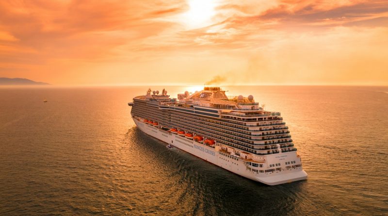 A cruise ship sailing at sunset