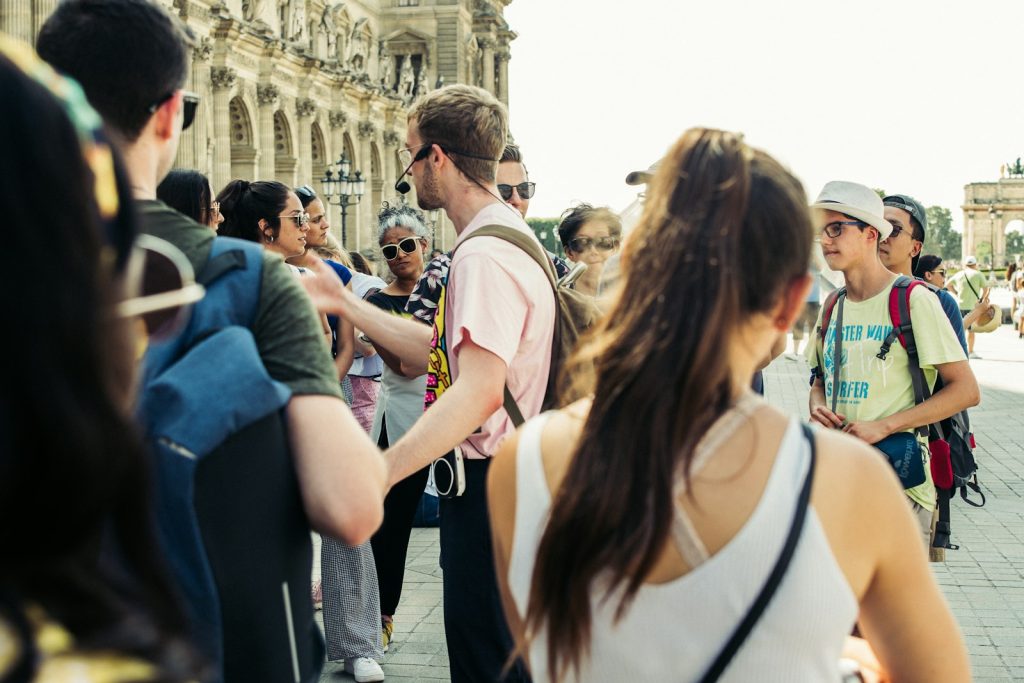 A group of visitors walking together through a city street
