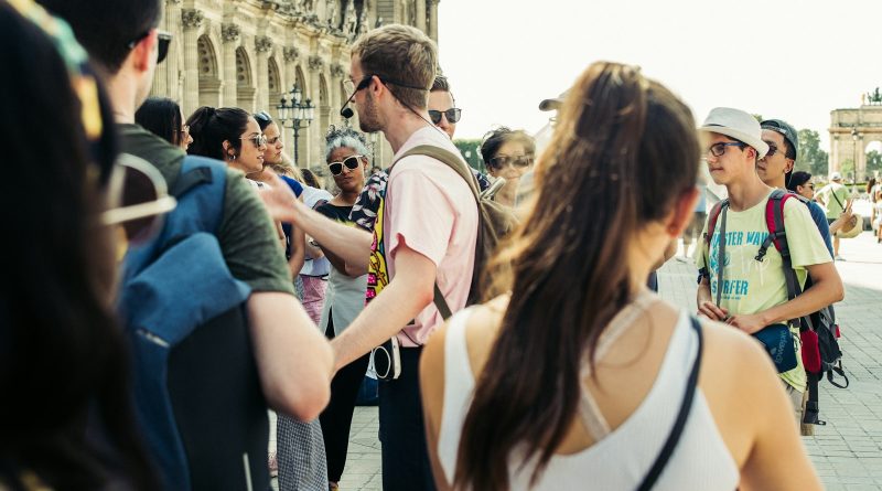 A group of visitors walking together through a city street