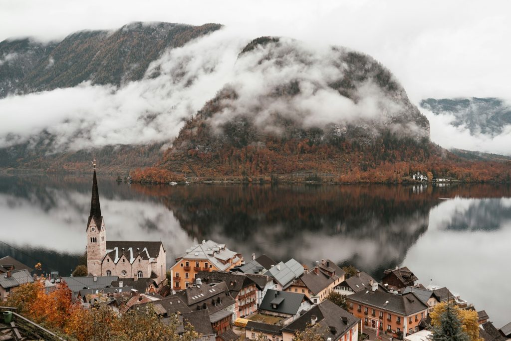 A lakeside village beneath snowy mountains