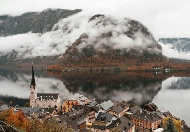 A lakeside village beneath snowy mountains