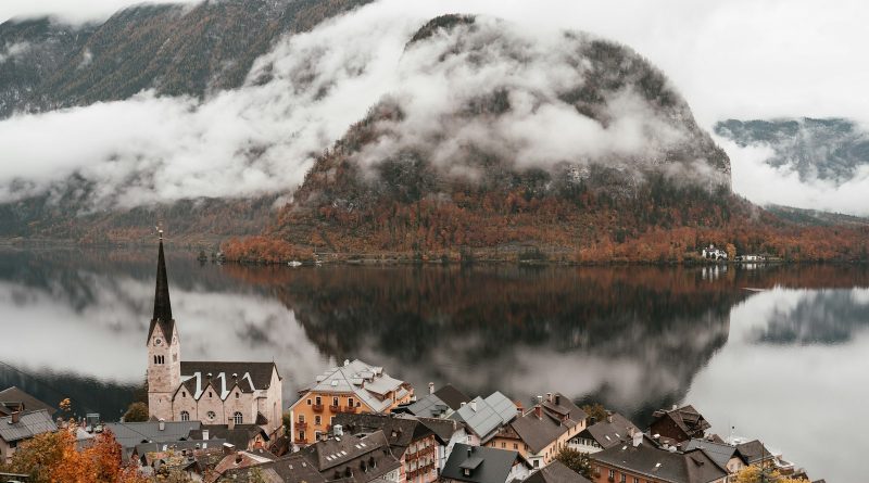 A lakeside village beneath snowy mountains
