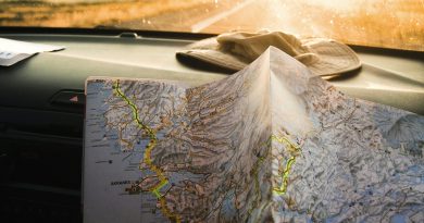 A traveler holding an open map in warm sunlight