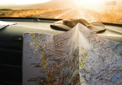 A traveler holding an open map in warm sunlight
